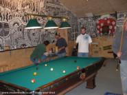 The Manshed: Pool game in progress and view of the big mural.
