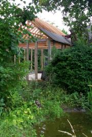 The frame goes up of shed - , 