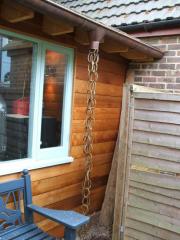 a stylish chain takes water into the soak away of shed - 'Shed and Son of Shed', Hampshire