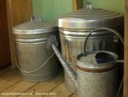 Potting soil & watering cans of shed - The Church of Gardening, New Hampshire