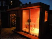 Wood gives a lovely warm glow at night of shed - One Grand Designs Shed, Liverpool