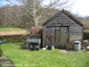 Another front view, with Anderson shelter/ wood store to the right. of shed - Wernfach Shed, Powys