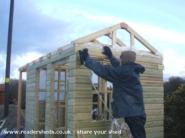 Wind Powered Shower Shed: Cladding on! That nail gun is priceless!