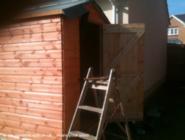 Frontish view as it's being built of shed - , 