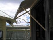 Shed Door Awning, wrought iron brackets of shed - ManBower, 
