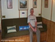 owner John on seat that converts to a bed of shed - The Railway Retreat, 