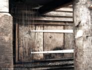 shower head and shutter of shed - The Net Hut Shed, East Sussex