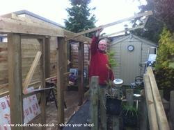 Attaching the swinging walls to double the capacity when spraying or entertaining of shed - The Stencil Shed, Wiltshire