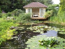 View across lilly pond of shed - Brocktonmere Lodge, Shropshire