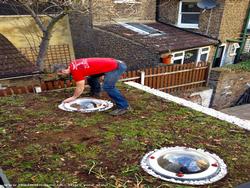 laying the green roof of shed - eco bike høøse, Greater London