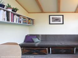 interior with desk and built-in couch of shed - Garden Fort, California