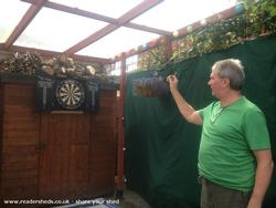 Tom playing darts of shed - Tom's Tavern and Soul-food Shack, Cheshire East
