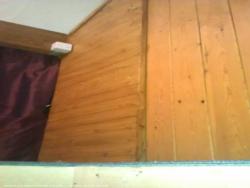 Looking up from trapdoor, showing curtained-off storage area to the left. of shed - The Shattic, Merseyside
