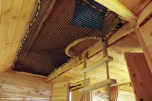Above the doors is a double bed platform - accessed by a rope and cedar ladder. Beside is a cargo net hammock for more sleepy people. of shed - Celyn Dawn, Monmouthshire