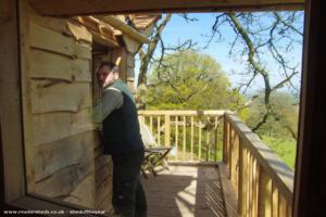 The balcony through the Nook window - Oli is there for scale - he also built it. of shed - Celyn Dawn, Monmouthshire