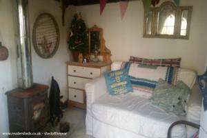 View from inside of side wall and sofa with chest of draws of shed - ENAK COTTAGE , Bedford