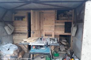 front open , storage doors open of shed - shed in a garage, Wiltshire