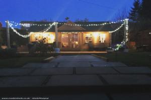 Front view at night of shed - Shebeen inn, Fife