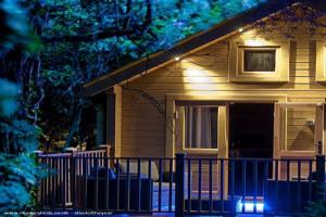 Rear at night of shed - Alum Chine log cabin, Dorset
