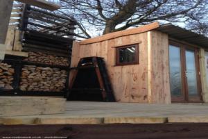 Outside log store and larch cladding of shed - The Kubb Pavilion, Fife