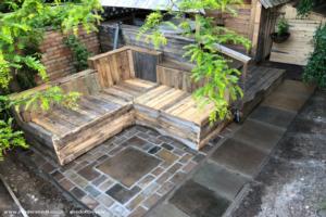 Patio seating area with wood shed extension of shed - Grownups Retreat, Bedfordshire