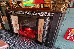 Reclaimed Victorian fireplace with fire “effect” of shed - The winchester, Staffordshire