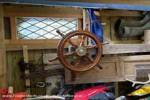 Ship's wheel of shed - Golden Behinde, Suffolk