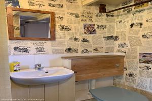 The ablutions offices featuring wallpaper made from broken up 1920s and 30s Boys Annuals of shed - Drovers Halt, Kent